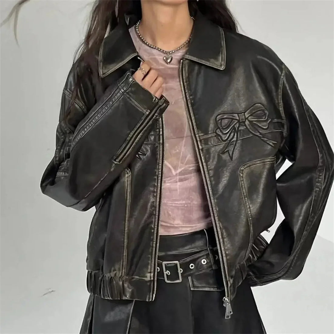 Women's edgy leather bomber jacket with bold pink bows